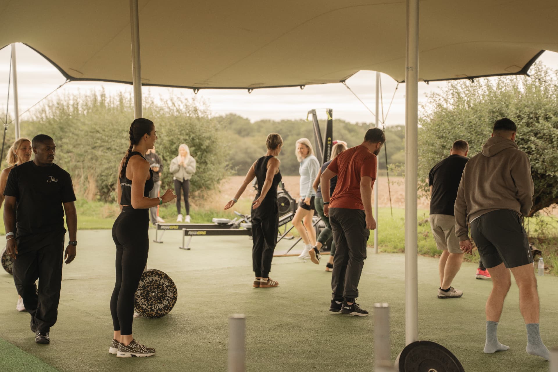 A team warming up together under the outdoor training canopy